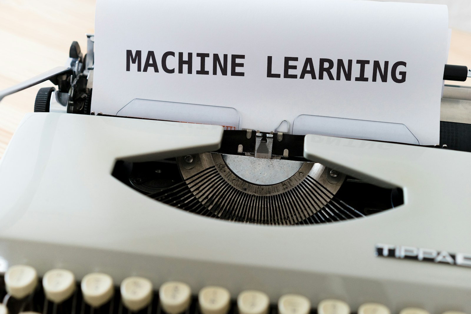 Typewriter with a sheet of paper reading Machine Learning
