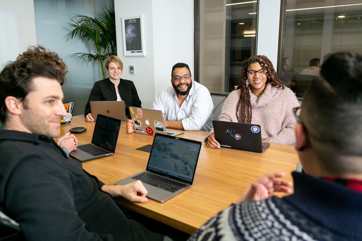 Product team working together on laptops