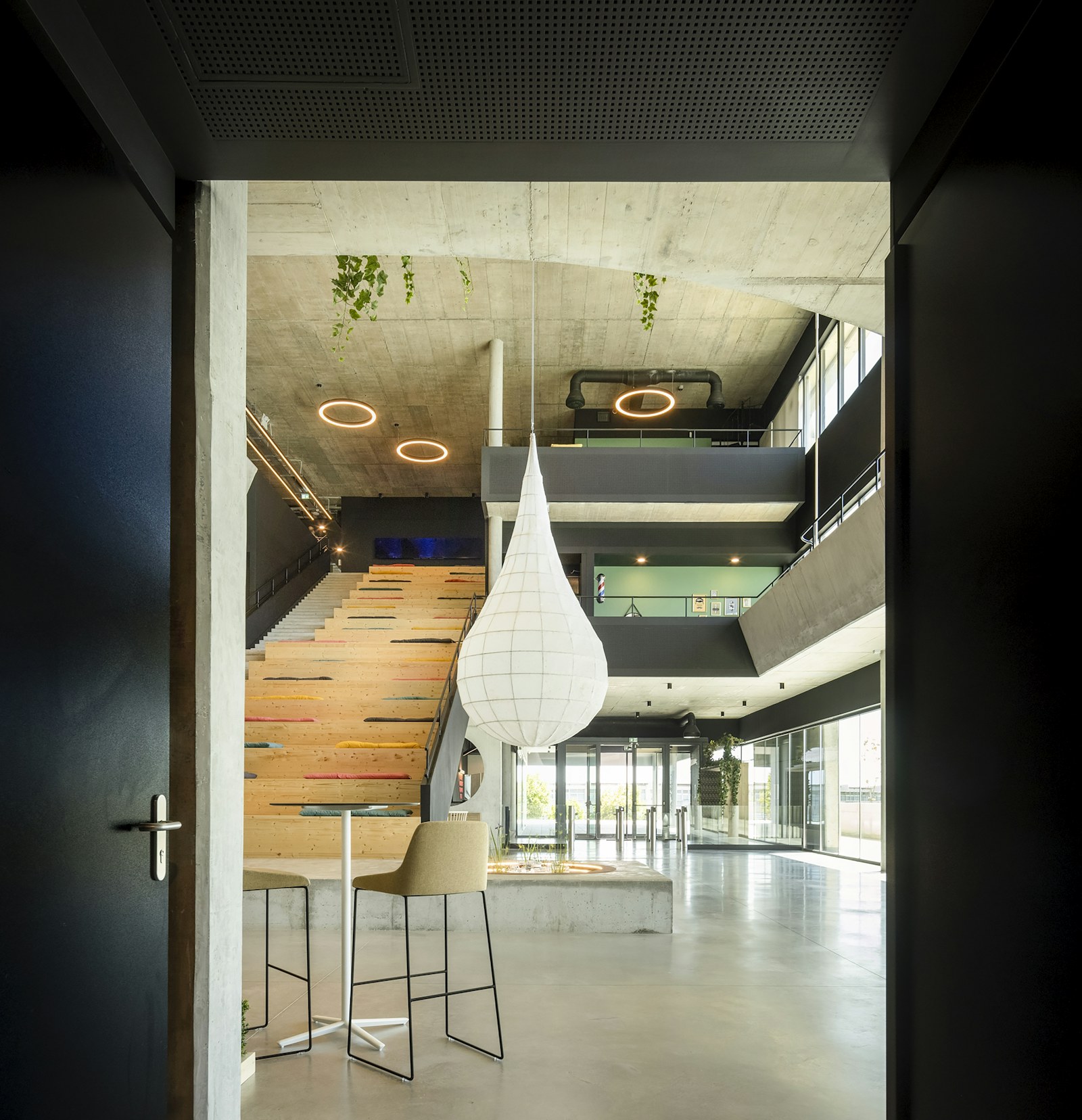 Modern open-plan office interior with a timber staircase