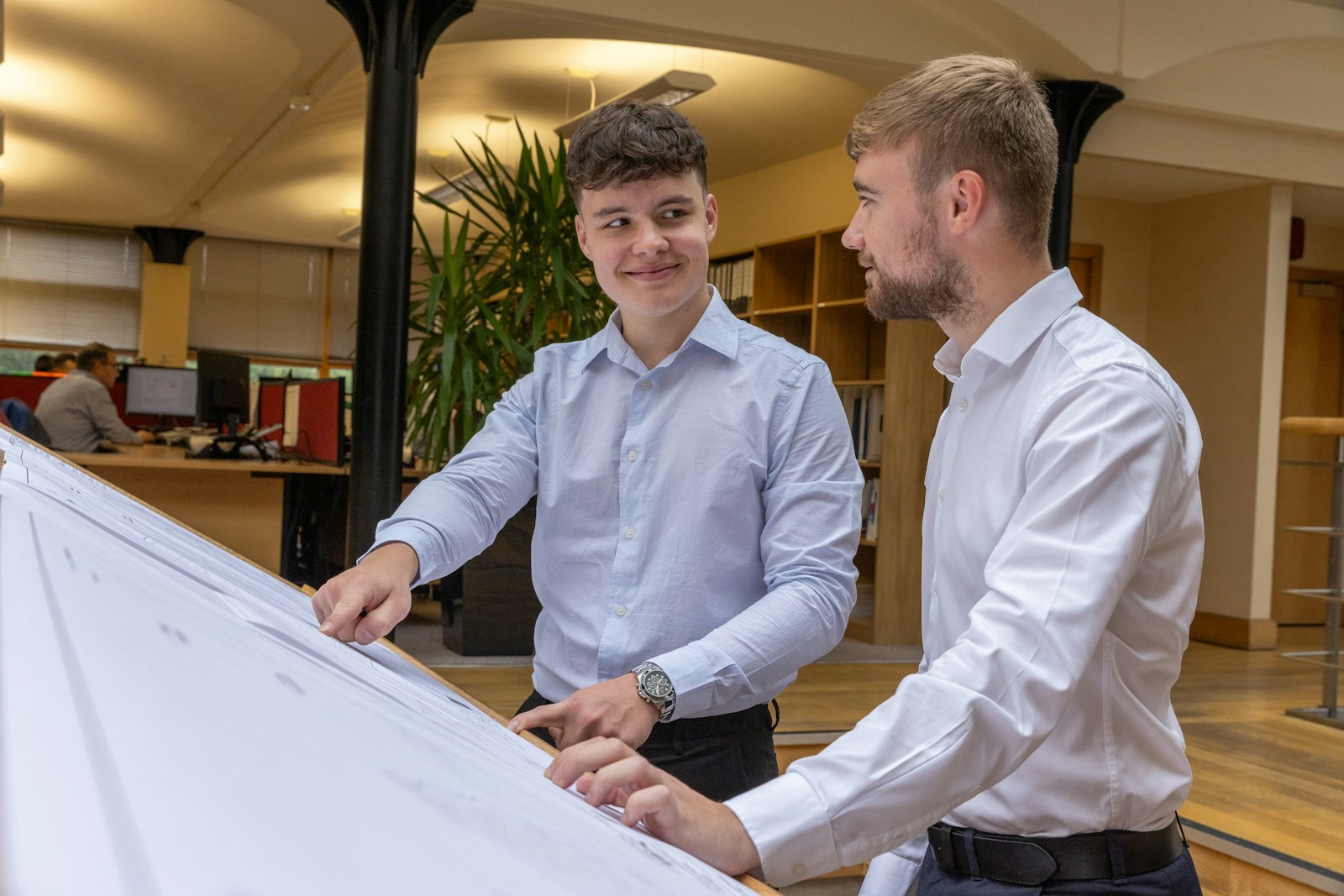 Two colleagues discussing a plan in an office